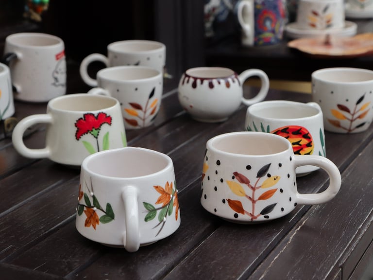 Handmade porcelain mugs with colourful hand-painted details
