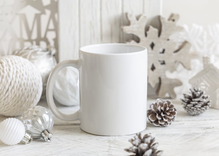 A white mug styled with wooden Christmas decorations and baubles