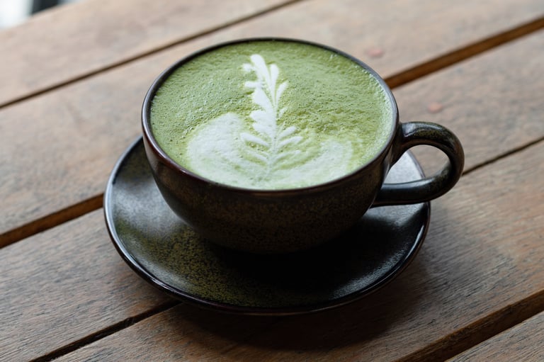 A latte served in a rustic ceramic cup